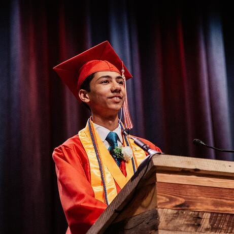 Graduated student giving a speech at his graduation ceremony