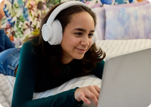 Student wearing a white pair of headphones